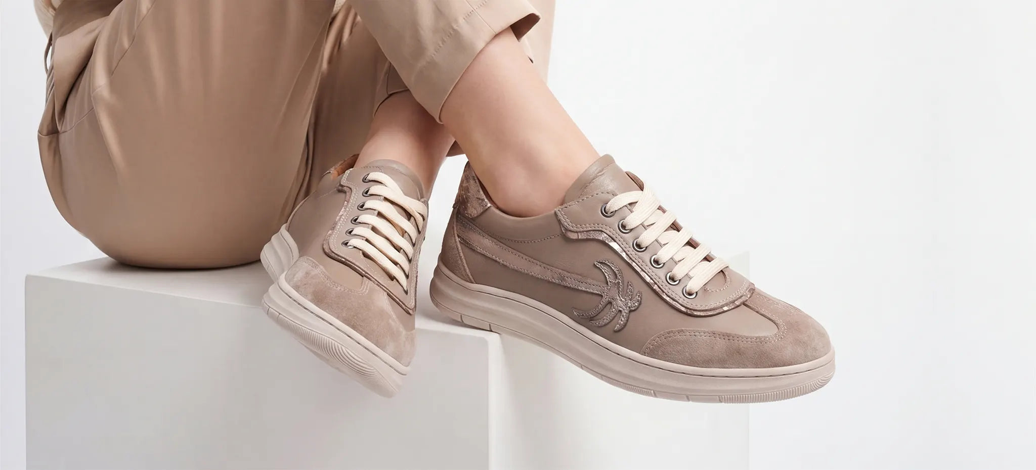 A women wears Calvano Cream Leather Casual Women Shoes With Palm Tree Details