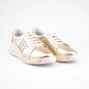 Pair of MrCalvano Laguna Beach comfort gold leather shoes with white laces and perforated side panels.