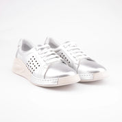 Pair of MrCalvano Laguna Beach women silver leather comfort shoes featuring a metallic silver upper, white laces, and a unique contoured sole against a white background.