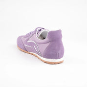 MrCalvano women's lavender leather and suede sneakers with white wavy details and gum sole, back-facing on white background.