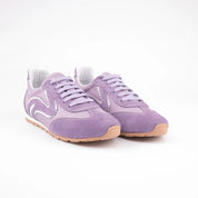 Pair of MrCalvano women's lavender leather and suede sneakers with white wavy details and gum sole, front-facing on white background.