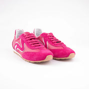 Side profile of women's pink leather sneakers in fuchsia suede with white wave detail and gum sole.