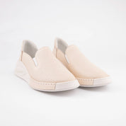 Calvano Malibu women's tan leather comfort sneakers with perforated upper and creamy off-white sculpted sole, front view.