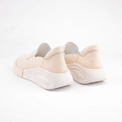 Calvano Malibu women's tan leather comfort sneakers with perforated upper and creamy off-white sculpted sole, pair back view.