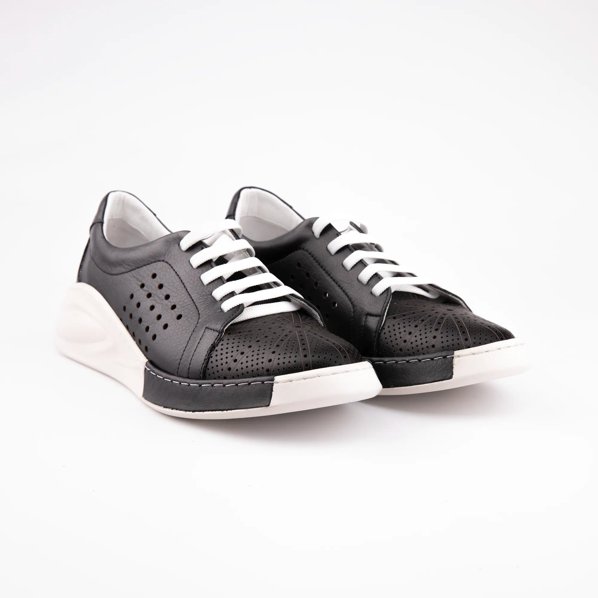 A pair of MrCalvano Marina Del Rey black leather comfort shoes featuring perforated uppers, white laces, and a sculpted white sole on a white background.