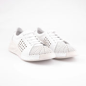 A studio shot of the MrCalvano Marina Del Rey white leather comfort shoes, emphasizing the delicate perforations, crisp white color, and refined shape. The image captures the shoe's understated elegance and robust construction, highlighting its potential for versatile styling in the United States.