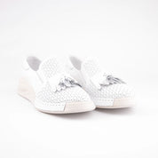 A United State studio shot showcasing the MrCalvano Newport Beach white leather women's slip-on shoes, highlighting the perforated texture and tassel detail.