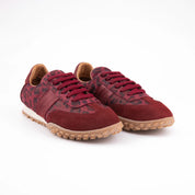Studio shot of MrCalvano Pebble Beach Leopard Burgundy women's leather sneakers, showcasing the subtle leopard print, deep red laces, and robust gum sole, ideal for San Francisco urban wear.