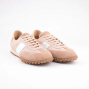 Pair of MrCalvano Pebble Beach salmon leather sneakers in a soft salmon color, featuring a white side stripe and light brown ridged rubber sole, viewed from a slight angle on a white background. USA
