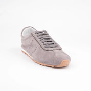 Exhibiting a sophisticated front-angle perspective, these MrCalvano Pismo Beach Grey leather sneakers for women highlight their sleek, low-profile silhouette 