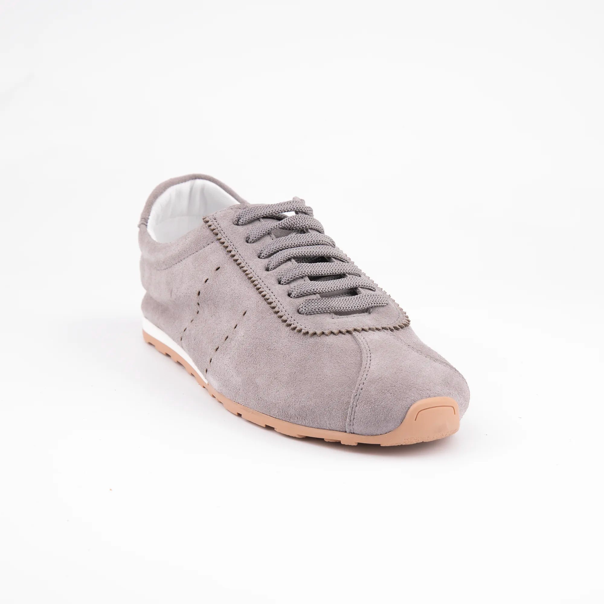 Exhibiting a sophisticated front-angle perspective, these MrCalvano Pismo Beach Grey leather sneakers for women highlight their sleek, low-profile silhouette 
