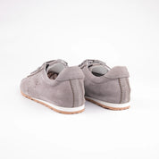 This precise rear perspective of the MrCalvano Pismo Beach Grey leather sneakers for women prominently displays the meticulously crafted heel counter, featuring distinctive vertical stitching that creates 