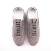 Presenting an immaculate overhead perspective, this pair of MrCalvano Pismo Beach Grey leather sneakers for women showcases their refined suede-like texture and perfectly aligned flat