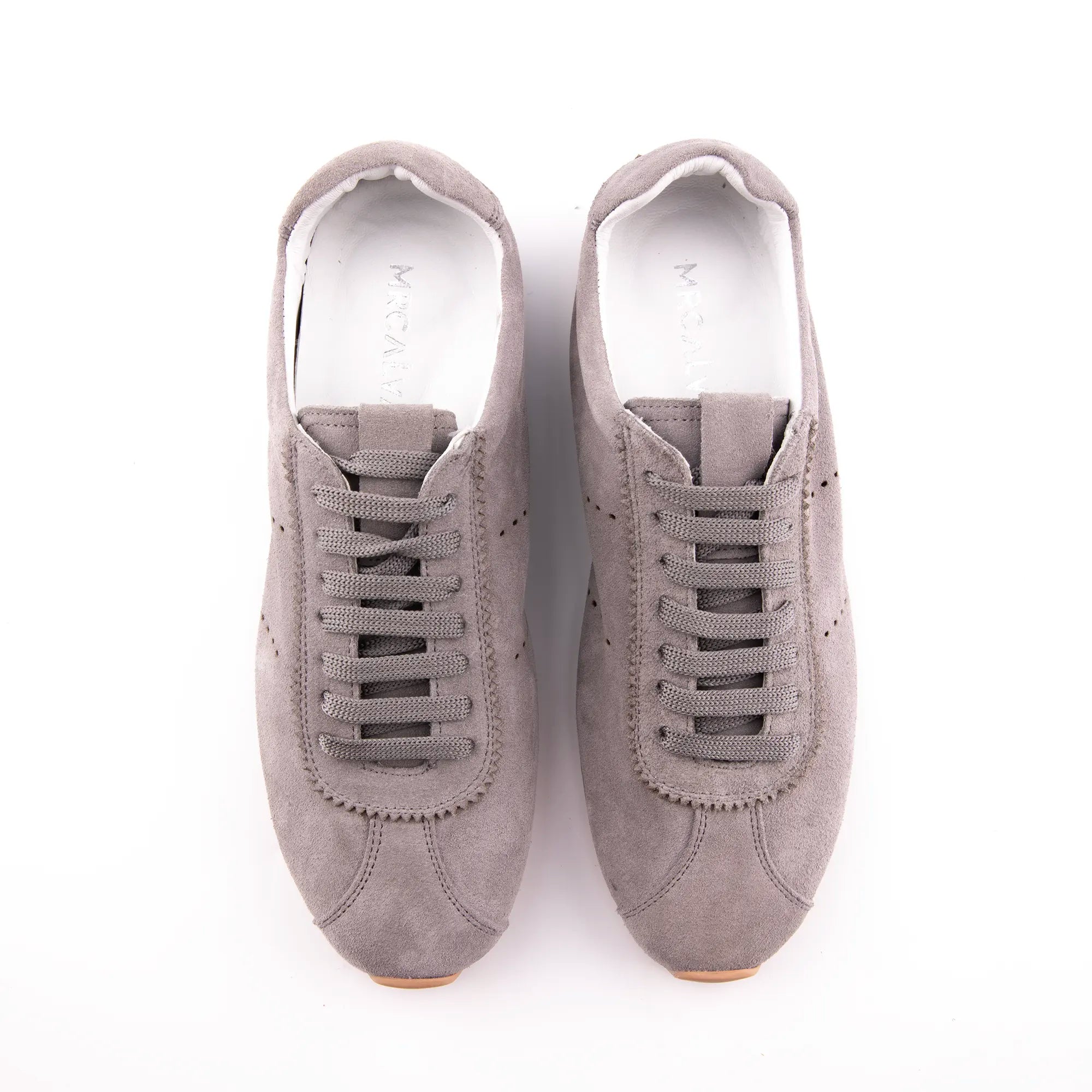 Presenting an immaculate overhead perspective, this pair of MrCalvano Pismo Beach Grey leather sneakers for women showcases their refined suede-like texture and perfectly aligned flat