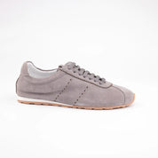 Presenting the MrCalvano Pismo Beach Grey sneakers, this detailed side profile captures the refined grey suede upper, featuring intricately braided laces and distinctive scall