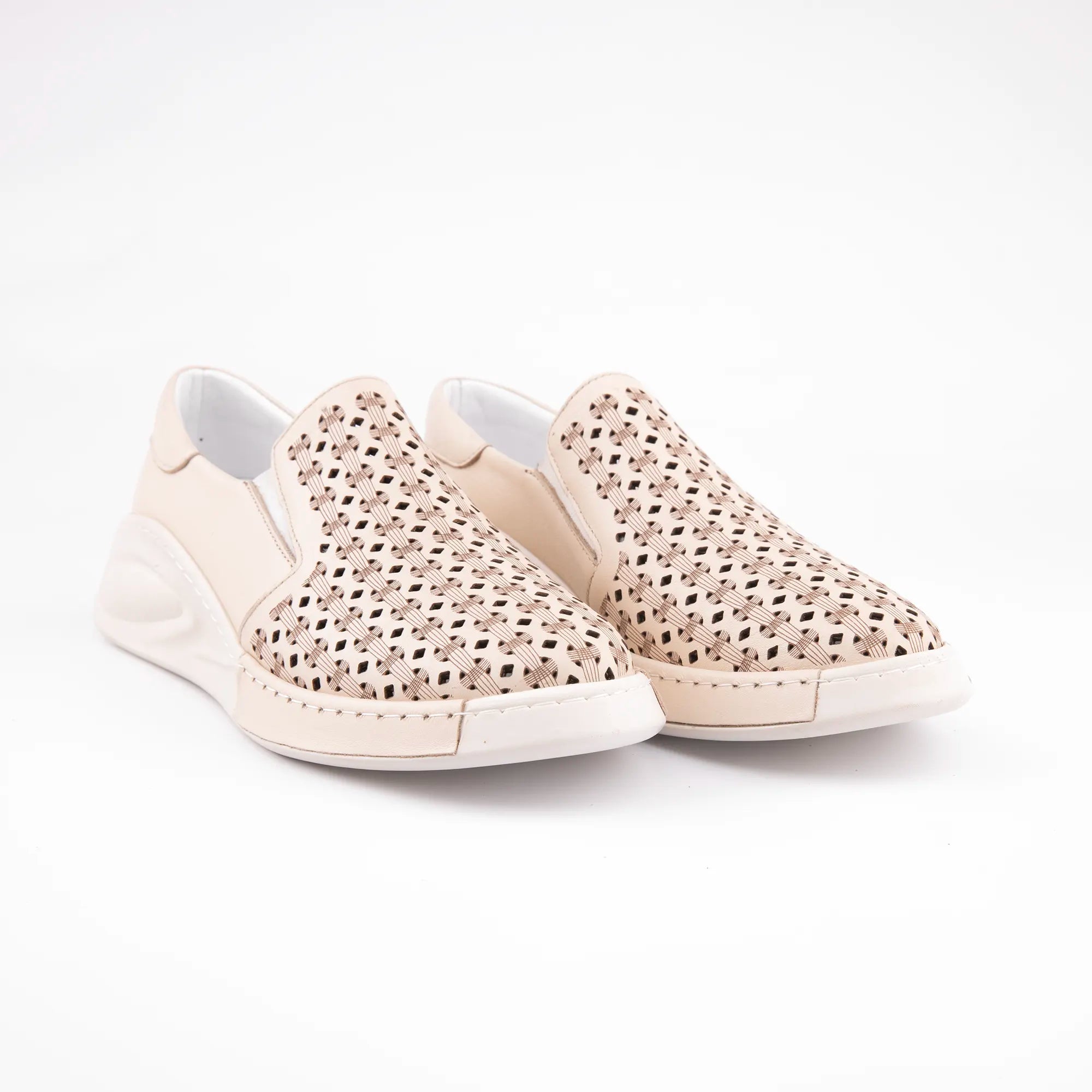 A pair of MrCalvano Solana Beach Tan perforated leather slip-on shoes for women, featuring an off-white sole and subtle stitching, photographed on a clean white background.