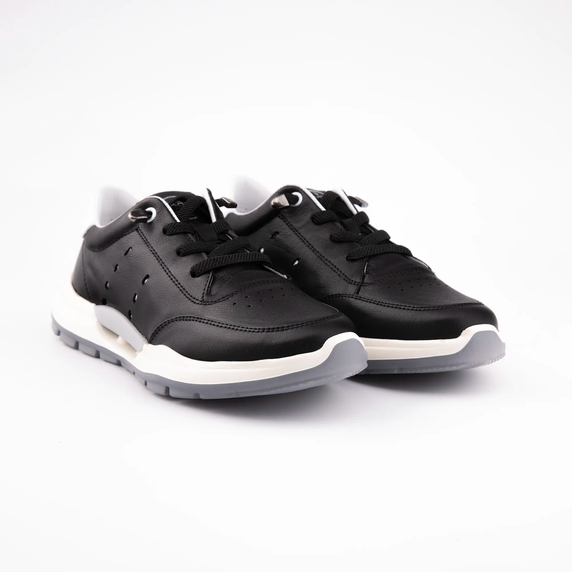A close-up view of the MrCalvano Venice Beach Black Leather Sneakers, highlighting the supple leather upper, the intricate perforated details, and the layered off-white and grey sole design, conveying both style and functional support.