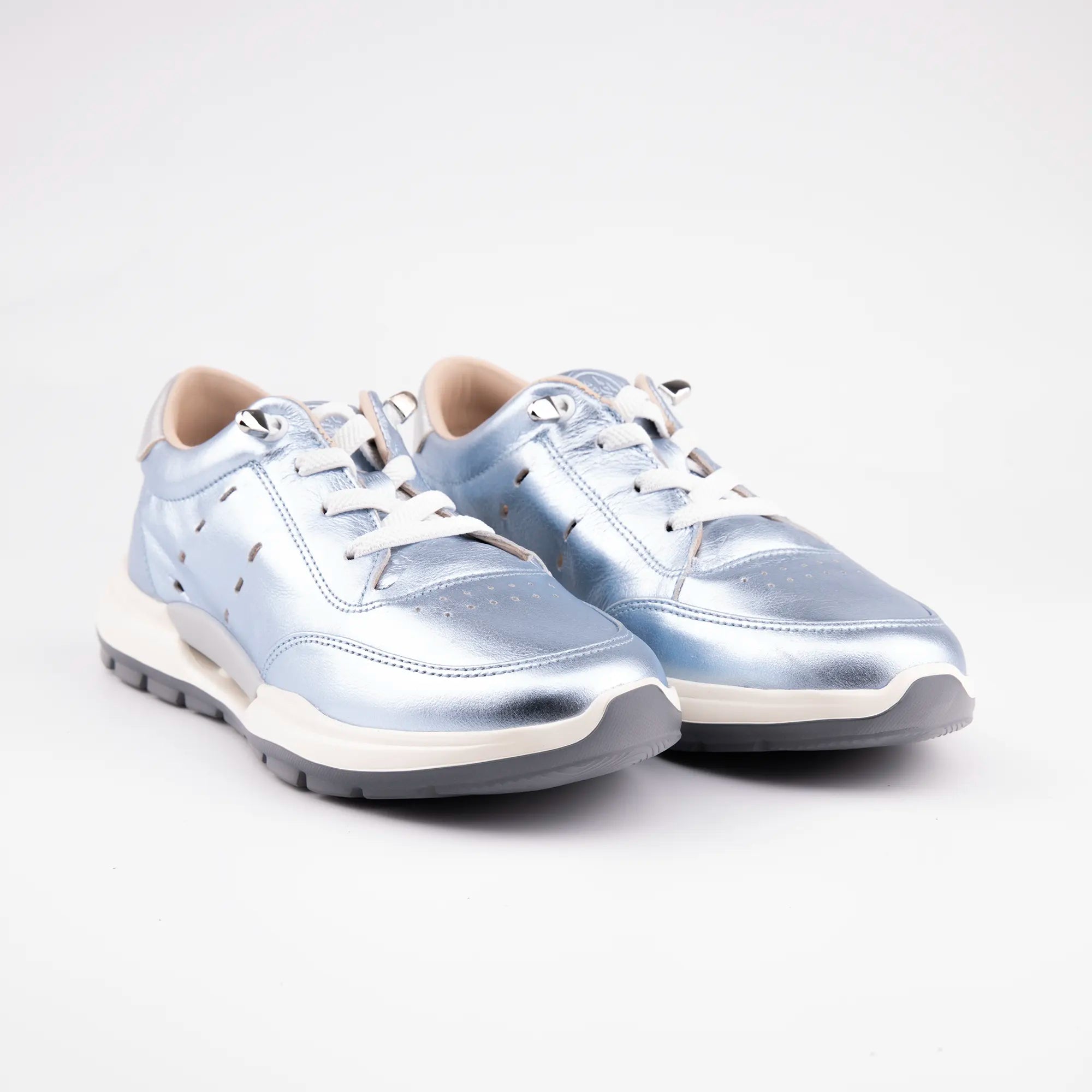 A pair of MrCalvano Venice Beach Ice Box Leather Women's Sneakers, showcasing their distinctive metallic blue upper, intricate lacing system with silver eyelets, and multi-layered sculpted sole, against a clean white background. The image highlights the shoe's contemporary aesthetic and material quality.