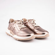 A pair of metallic bronze leather women's sneakers with a distinct white and beige layered sole, shown against a clean white background.