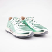 A pair of MrCalvano Venice Beach women's low-top sneakers in iridescent mint green leather, featuring off-white laces, a cream midsole, and dark grey outsole, displayed on a clean white background. Visible side perforations enhance breathability, and a metallic silver heel tab adds detail. Optimized for casual urban style in the United States.