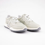 A pair of MrCalvano Venice Beach Mint Leather Women Casual Shoes, photographed at a slight angle on a clean white background, highlighting the pale mint green leather upper, bright white laces, off-white sculpted midsole, and dark grey textured outsole. The perforations on the side panel and the metallic lace eyelets are visible.